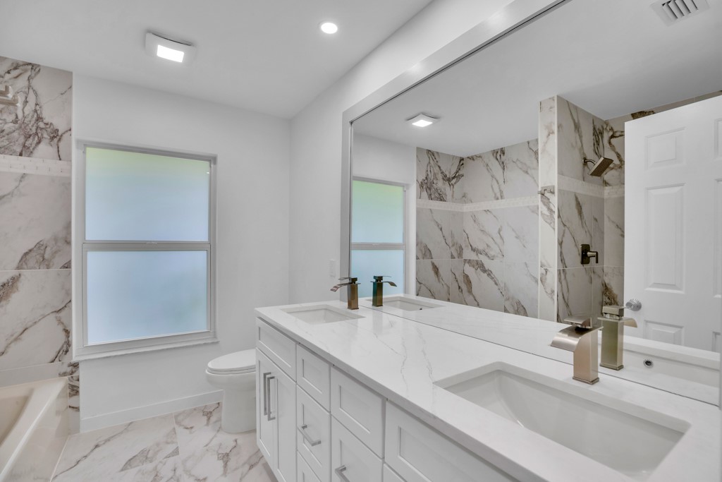 4384 2nd Square Southwest Vero Beach, FL 32968 - Photo 23 of 36 a bathroom with a sink and a toilet