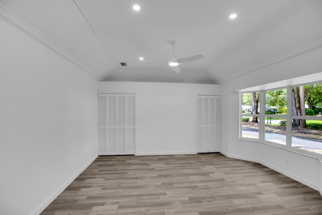 4384 2nd Square Southwest Vero Beach, FL 32968 - Photo 25 of 36 an empty room with wooden floor and windows