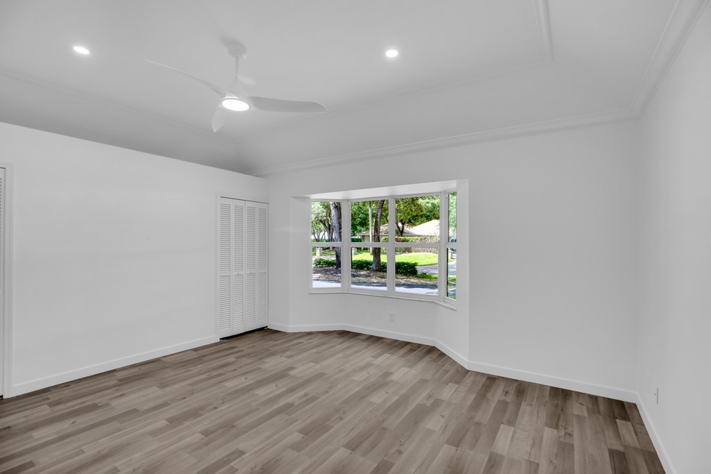 4384 2nd Square Southwest Vero Beach, FL 32968 - Photo 26 of 36 an empty room with wooden floor and windows