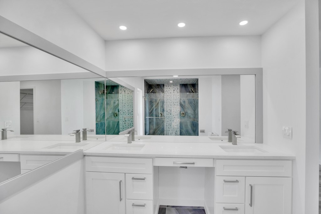 4384 2nd Square Southwest Vero Beach, FL 32968 - Photo 27 of 36 a bathroom with a sink and a mirror