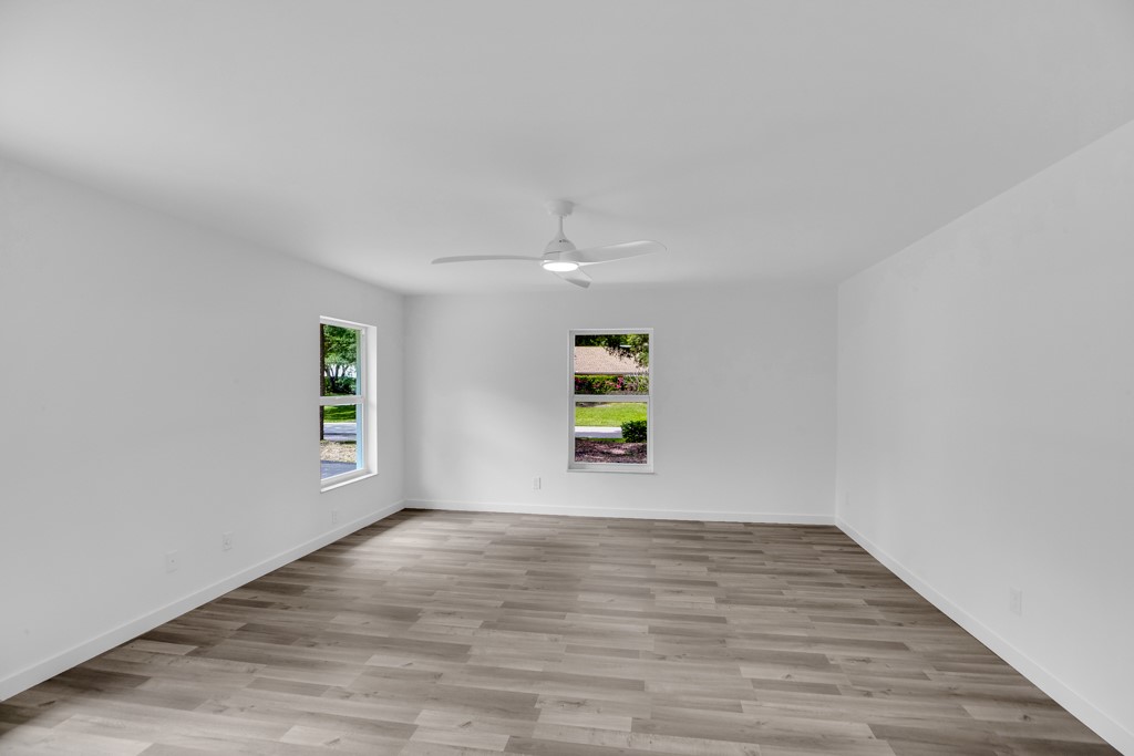4384 2nd Square Southwest Vero Beach, FL 32968 - Photo 29 of 36 a view of an empty room with a window and wooden floor