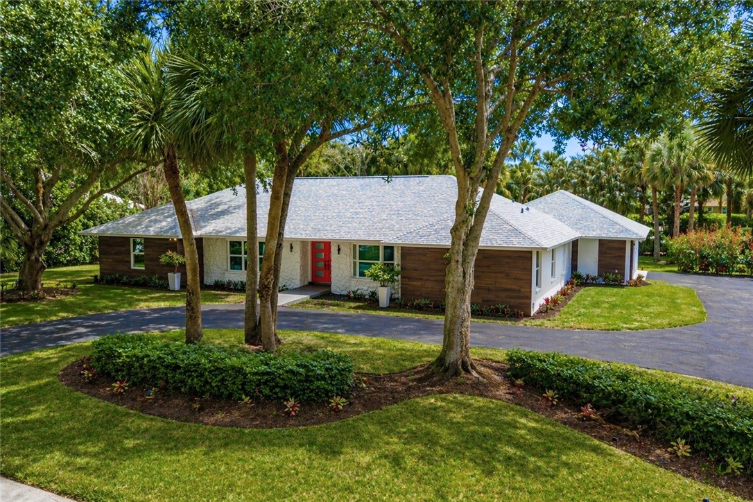 4384 2nd Square Southwest Vero Beach, FL 32968 - Photo 3 of 36 a front view of a house with garden