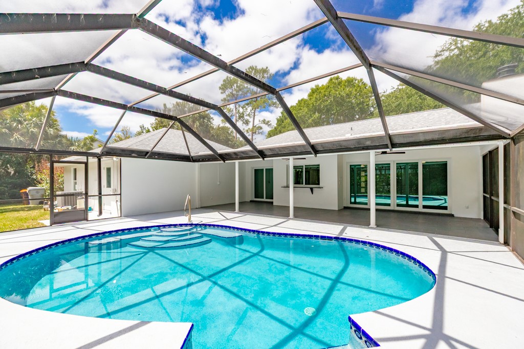 4384 2nd Square Southwest Vero Beach, FL 32968 - Photo 35 of 36 a view of an house with backyard and swimming pool