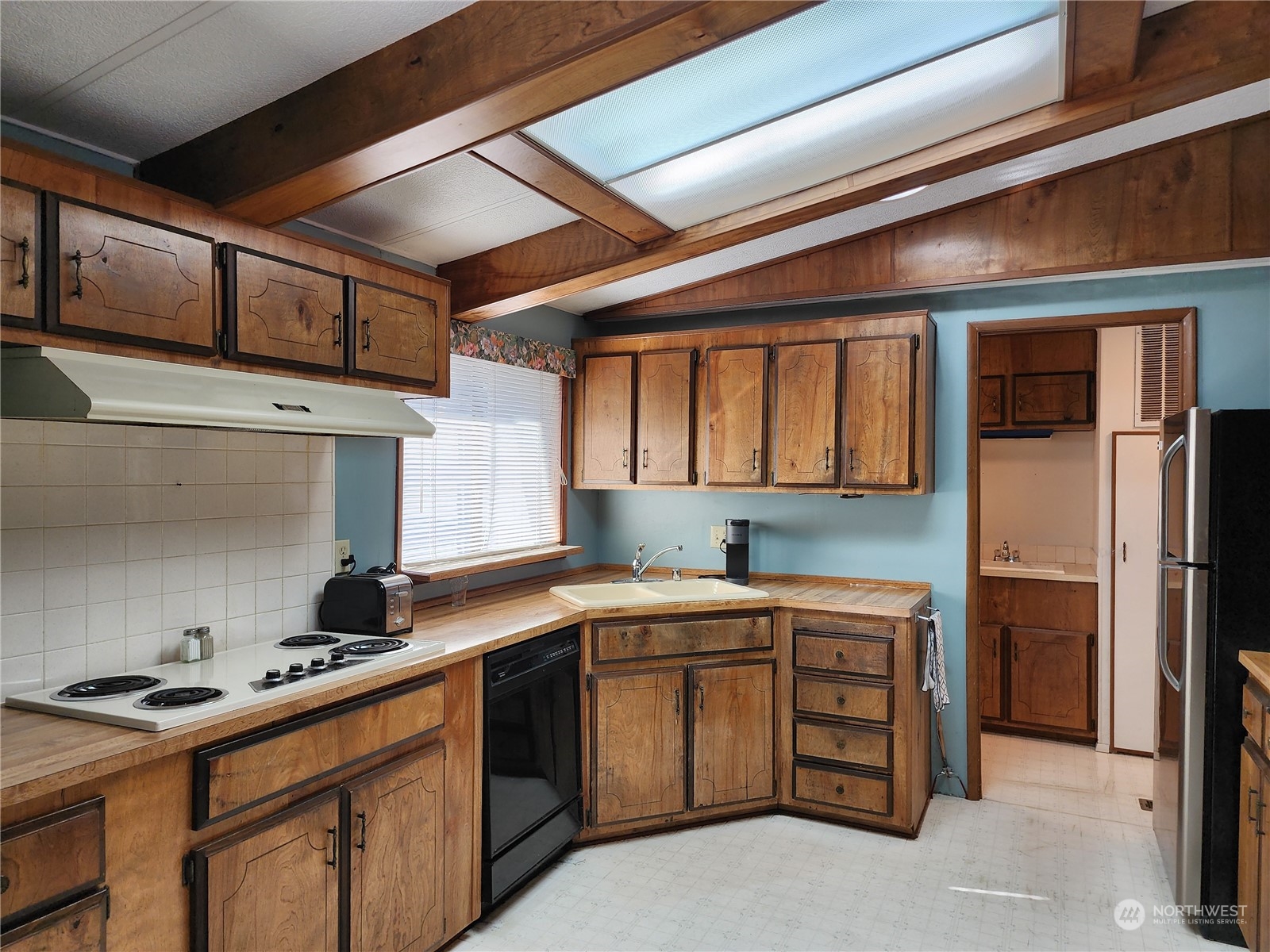 23706 Lake Drive West Bothell, WA 98021 - Photo 15 of 24 a kitchen with a stove a sink and a refrigerator