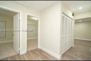 an empty room with wooden floor