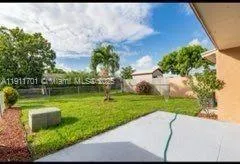 a view of a garden with a house