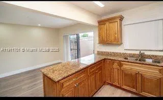 a kitchen with stainless steel appliances granite countertop a sink and cabinets