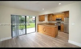 a kitchen with a stove a sink and a refrigerator