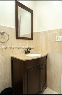 a bathroom with a sink vanity and a mirror