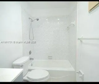 a bathroom with a bathtub a toilet and a shower