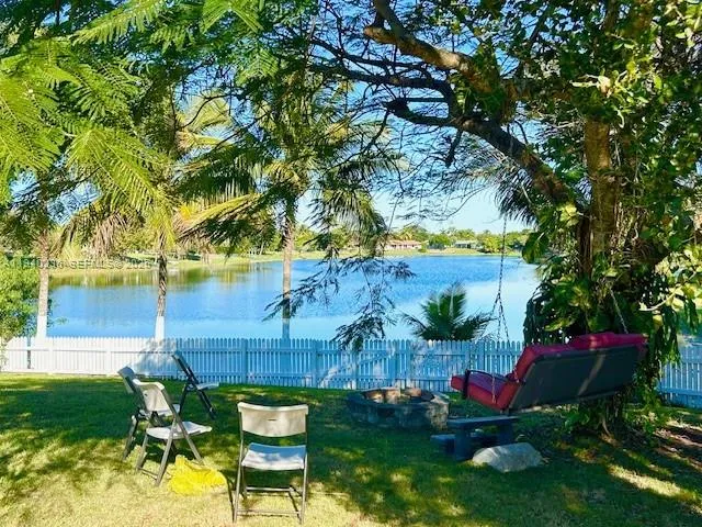 a view of a chairs and table in the garden