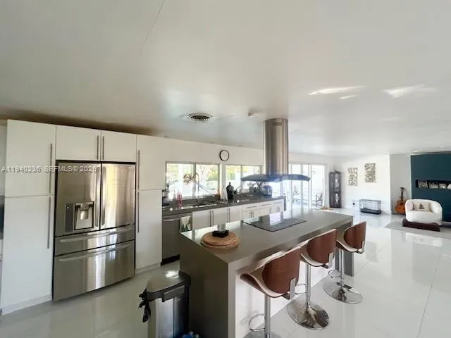 a kitchen with refrigerator and stove