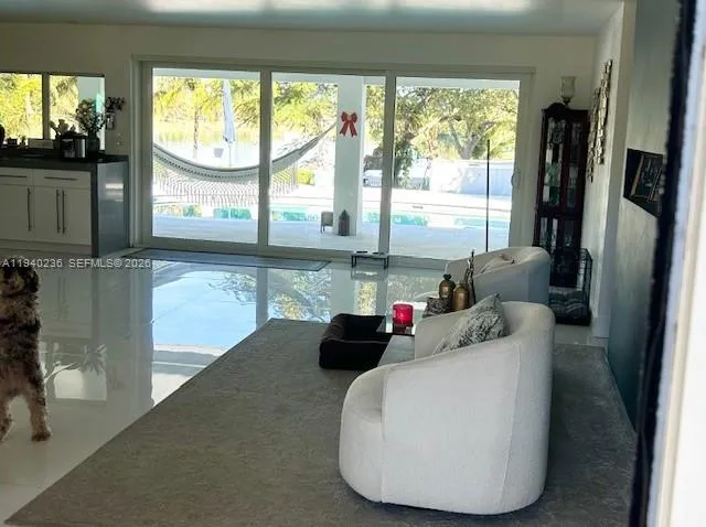 a kitchen with a large window and a refrigerator