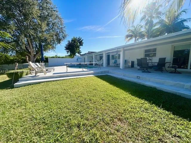 a view of a house with swimming pool and sitting area