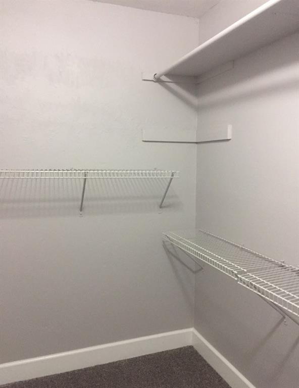 3305 Spaniel Drive Austin, TX 78759 - Photo 12 of 20 Functional wire shelving and a closet rod provide essential storage in this organized space.
