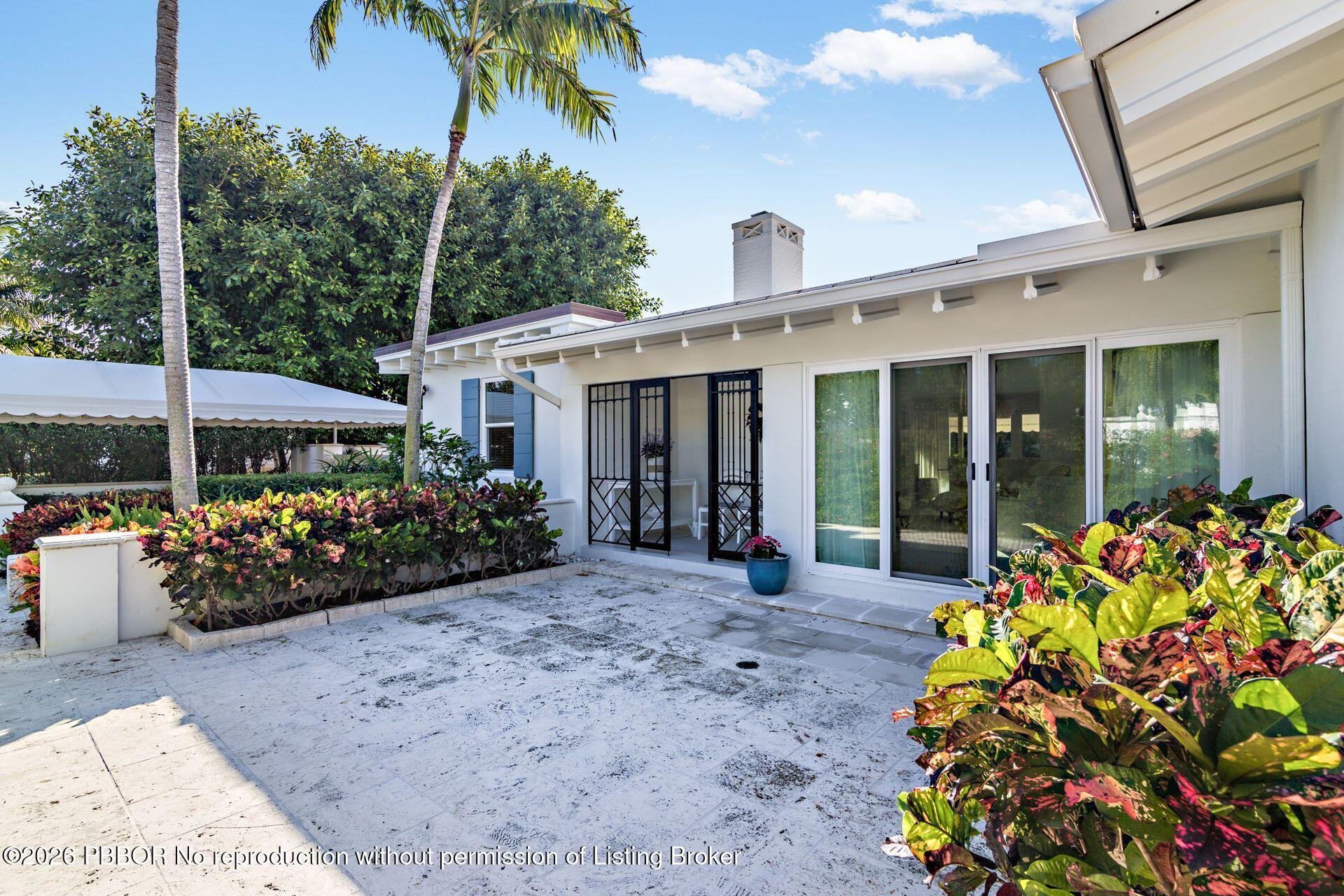 224 Churchill Road West Palm Beach, FL 33405 - Photo 3 of 33 a view of a house that has a flower garden