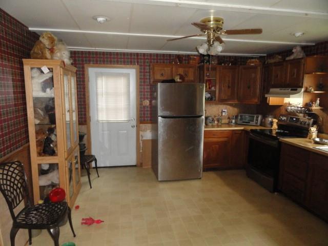 781 Herman Road Butler, PA 16002 - Photo 5 of 15 a kitchen with a refrigerator a stove top oven a dining table and chairs