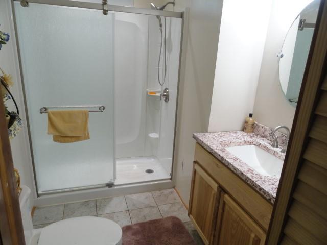 781 Herman Road Butler, PA 16002 - Photo 8 of 15 a bathroom with a granite countertop sink toilet and shower