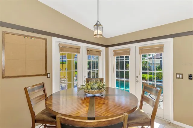 a dining room with furniture a chandelier and wooden floor