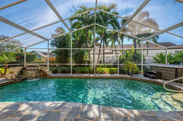 a view of a chair and table in backyard of the house
