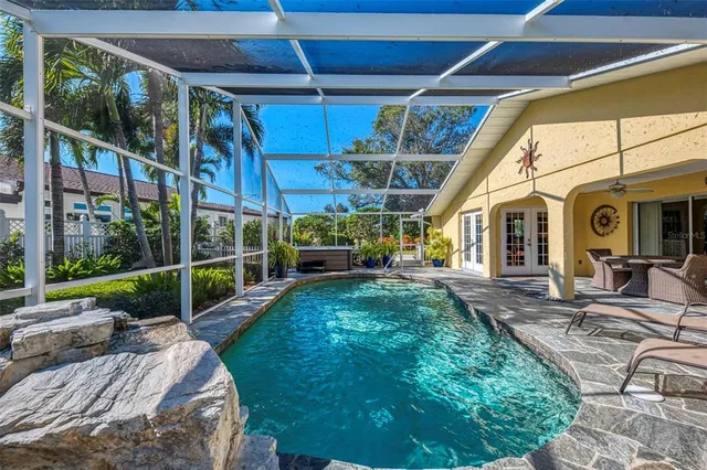 a view of a house with a yard and potted plants
