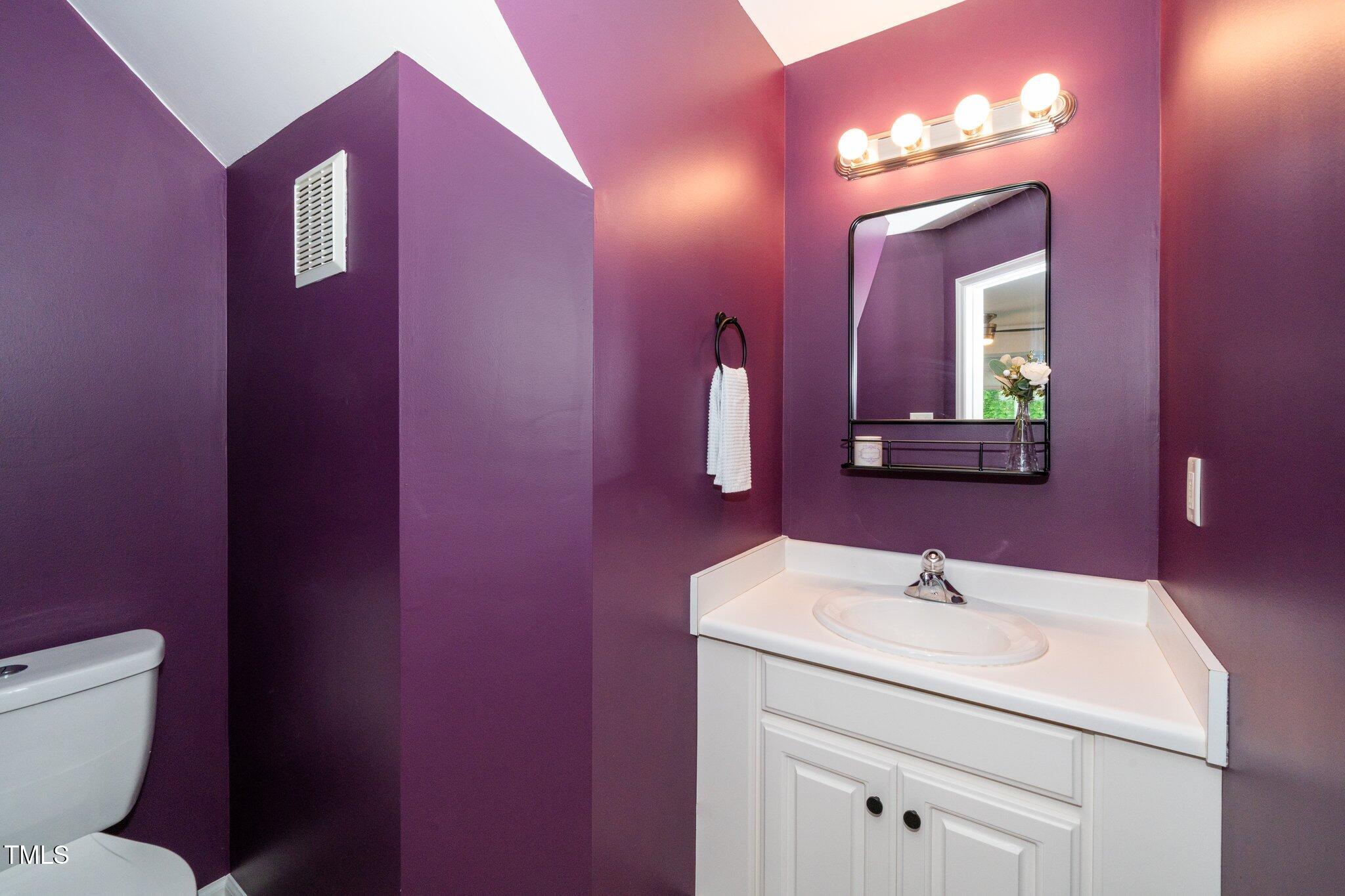 8009 Tobin Place Raleigh, NC 27612 - Photo 12 of 29 a bathroom with a toilet sink and mirror