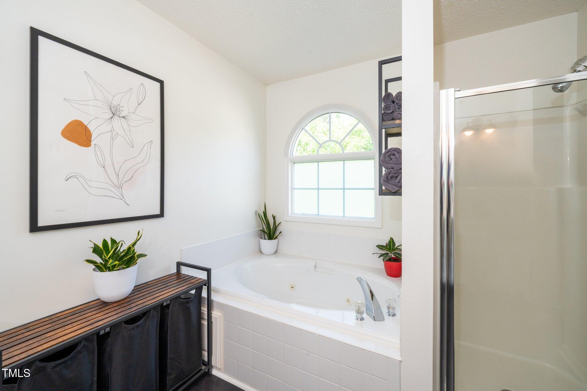 8009 Tobin Place Raleigh, NC 27612 - Photo 19 of 29 a bath tub sitting next to a window