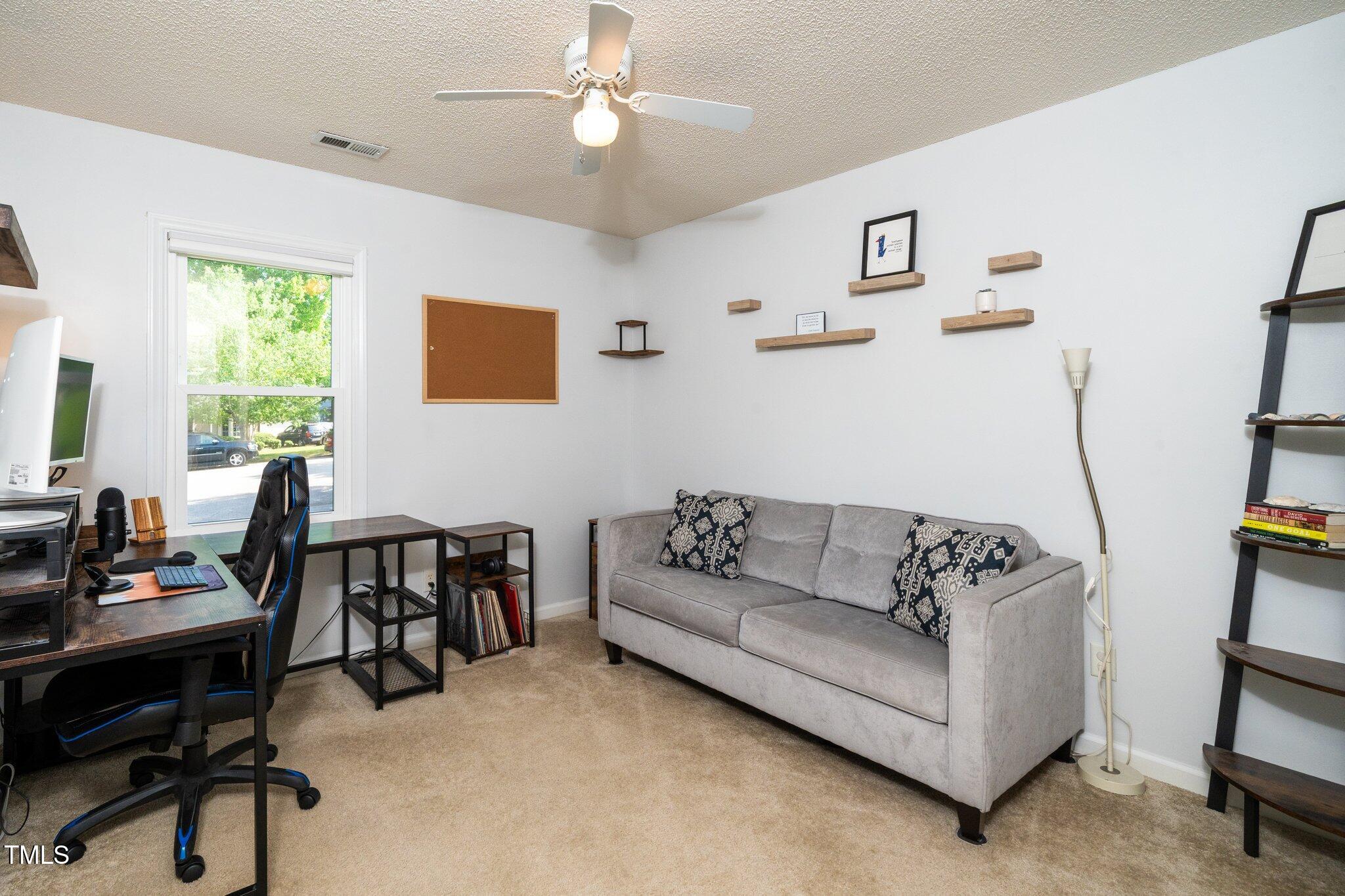 8009 Tobin Place Raleigh, NC 27612 - Photo 22 of 29 a living room with furniture and a window
