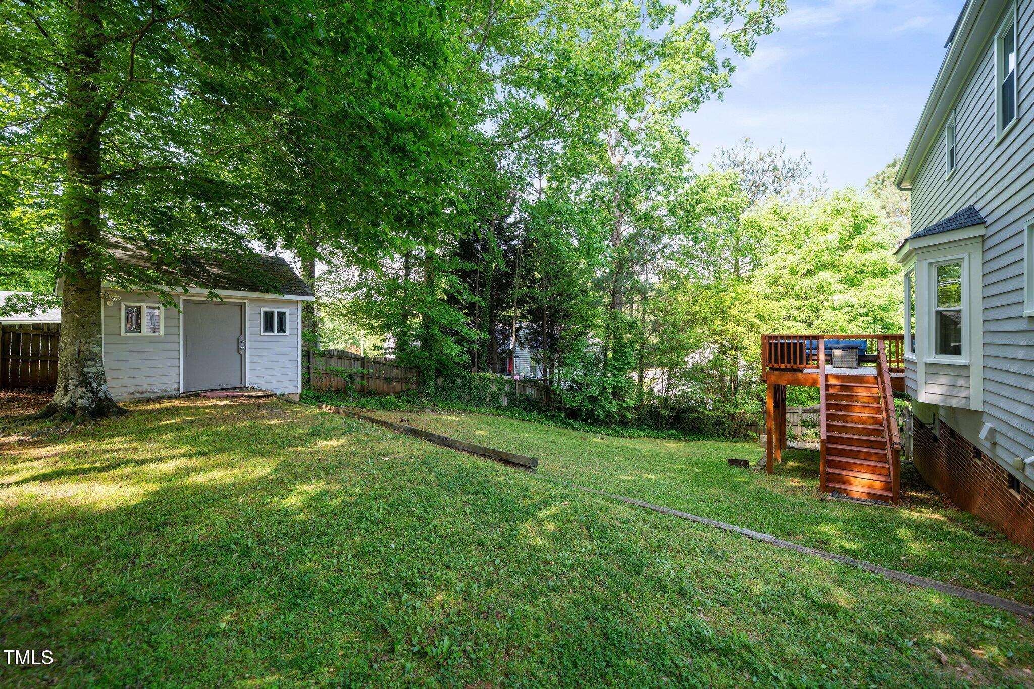 8009 Tobin Place Raleigh, NC 27612 - Photo 26 of 29 a backyard of a house with barbeque oven and wooden fence