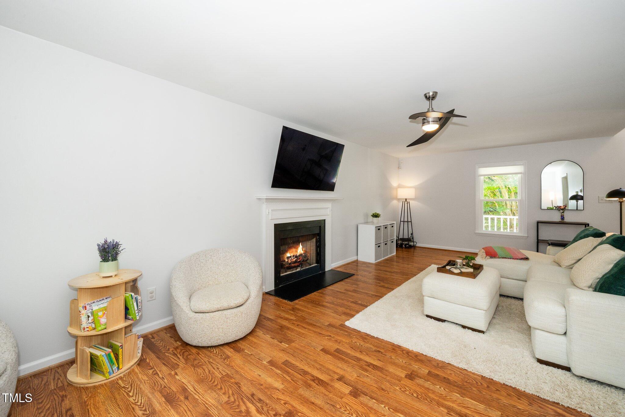 8009 Tobin Place Raleigh, NC 27612 - Photo 6 of 29 a living room with furniture and a fireplace