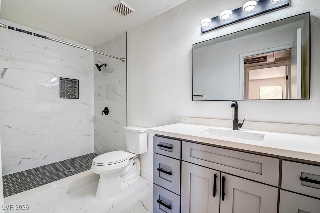 5121 South Lindell Road, Unit 206 Las Vegas, NV 89118 - Photo 9 of 34 Full bathroom featuring vanity, a marble finish shower, and light marble finish floors