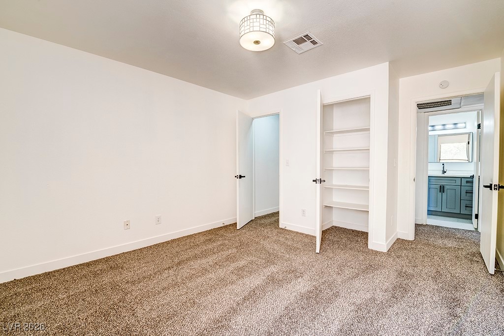 5121 South Lindell Road, Unit 206 Las Vegas, NV 89118 - Photo 14 of 34 Unfurnished bedroom with carpet floors and a closet