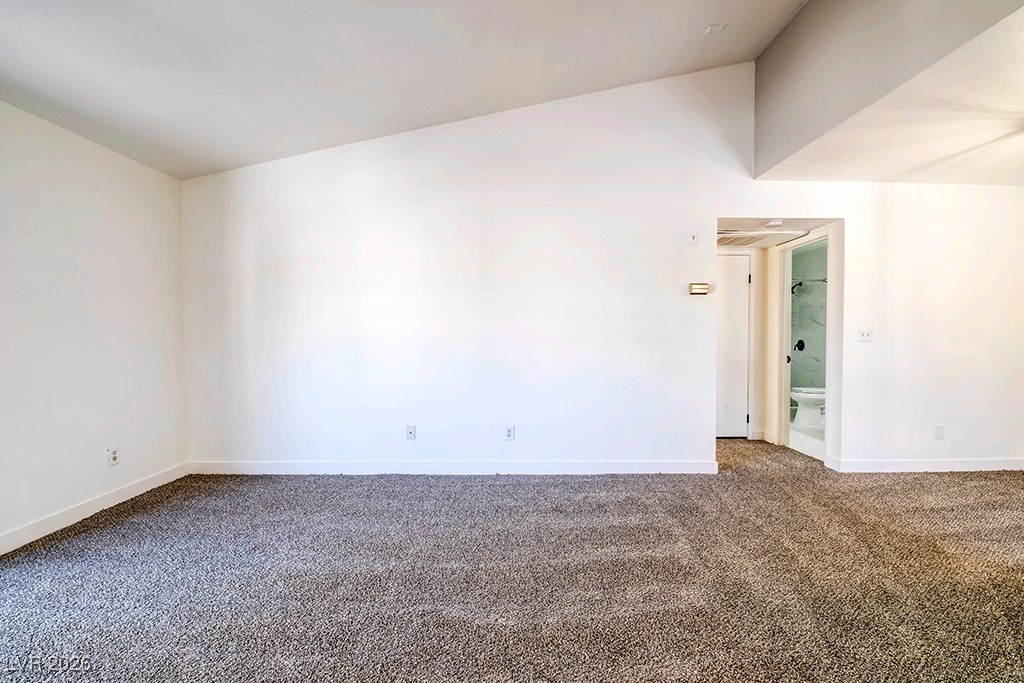 5121 South Lindell Road, Unit 206 Las Vegas, NV 89118 - Photo 21 of 34 Spare room featuring dark carpet and lofted ceiling
