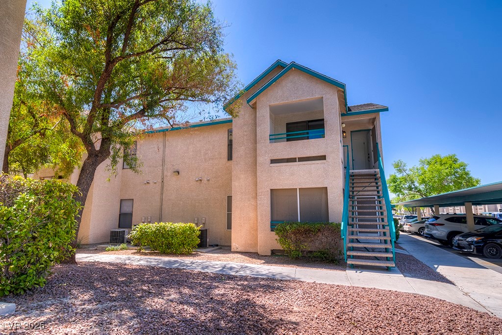 5121 South Lindell Road, Unit 206 Las Vegas, NV 89118 - Photo 3 of 34 View of front of home with stairway and stucco siding
