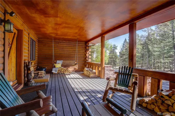 a view of balcony with couch and chairs