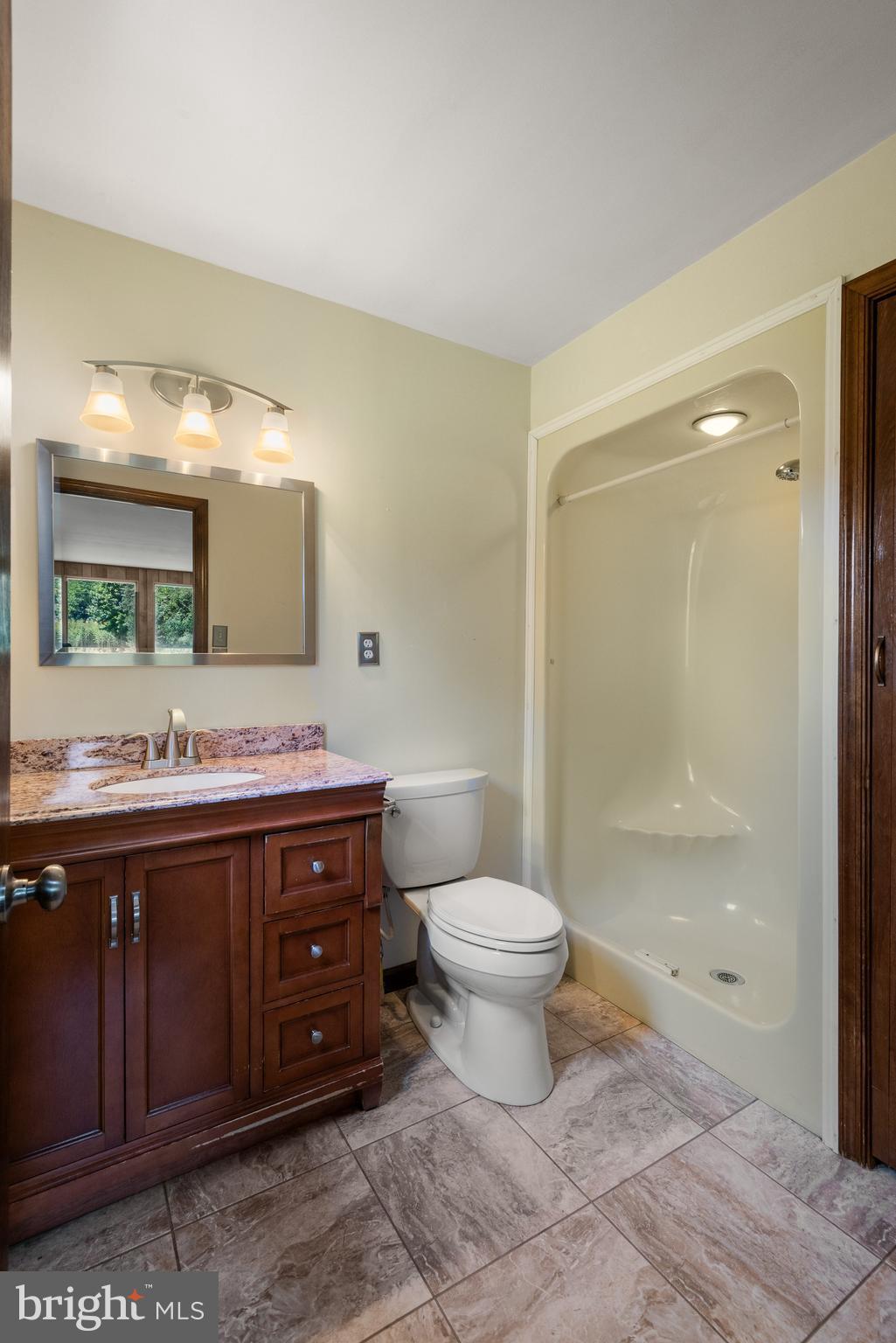 108 Sheeder Road Phoenixville, PA 19460 - Photo 19 of 42 a bathroom with a toilet a sink and a large mirror