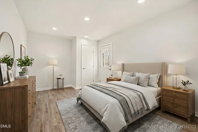 an empty room with wooden floor and ceiling fan
