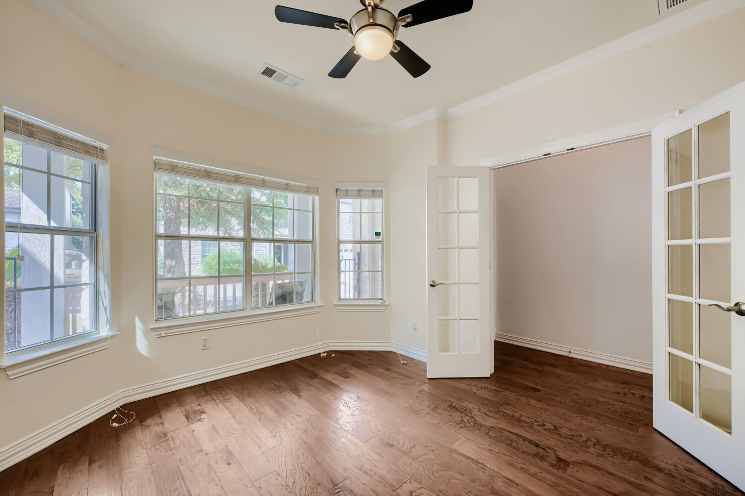 6715 Windrift Way, Unit 28 Austin, TX 78745 - Photo 9 of 19 Spacious home office or bonus room with French doors and a wall of window for natural light and view.