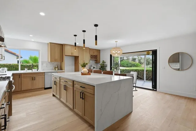 a view of a room with wooden floor and a bathroom sink