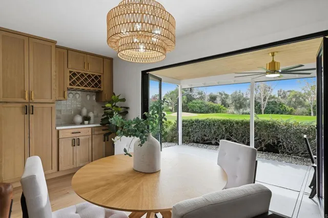a living room with furniture a floor to ceiling window and a table