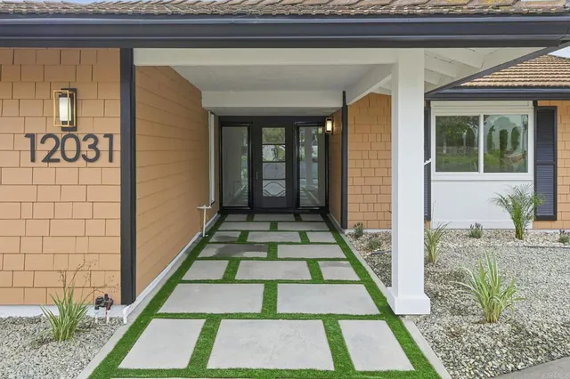 a kitchen with stainless steel appliances a sink a refrigerator and cabinets