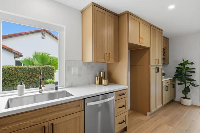 a living room with furniture a flat screen tv and a large window