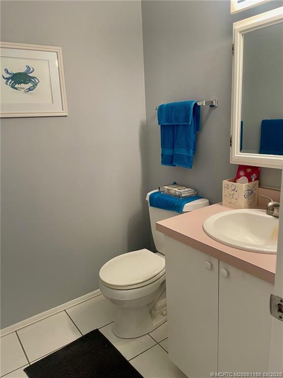 2600 Southeast Ocean Boulevard, Unit A12 Stuart, FL 34996 - Photo 8 of 17 a bathroom with a sink a toilet and mirror