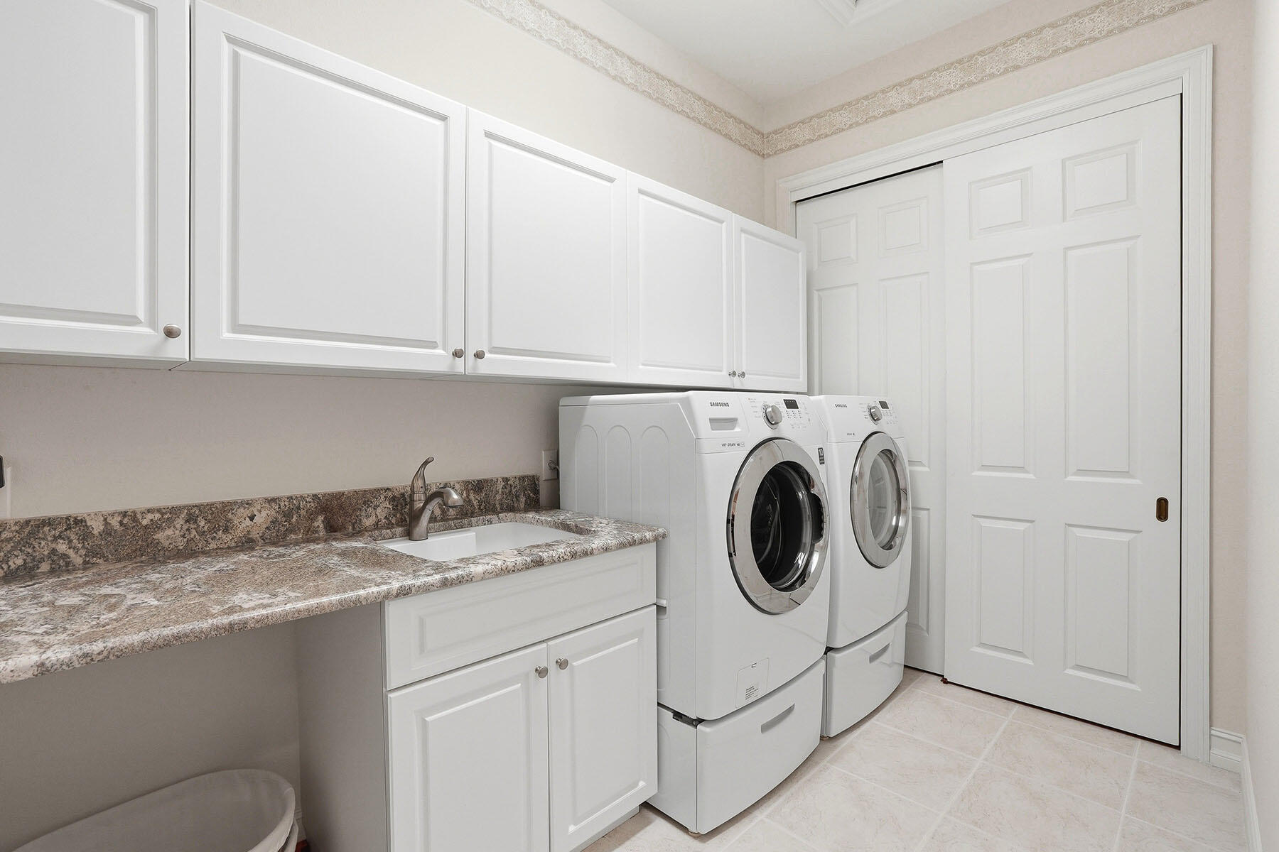 8605 Champions Point, Unit 103 Naples, FL 34113 - Photo 36 of 44 a utility room with sink dryer and washer