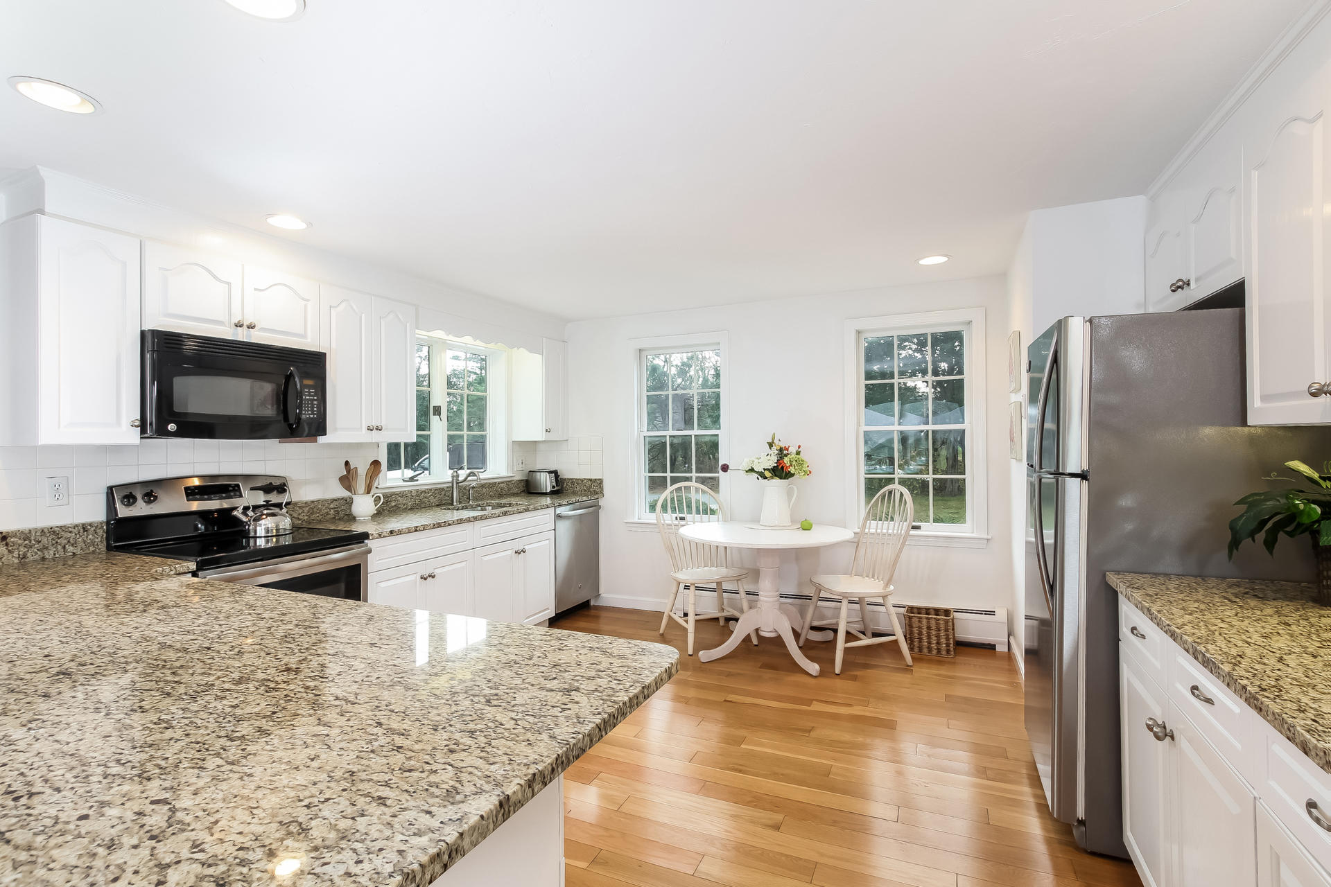 12 Governor Prence Road Brewster, MA 02631 - Photo 11 of 32 a large white kitchen with granite countertop lots of counter top space and stainless steel appliances
