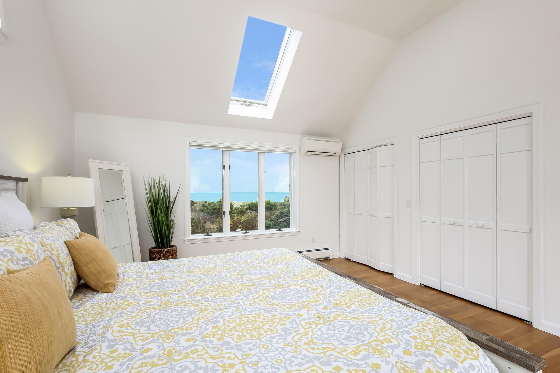 12 Governor Prence Road Brewster, MA 02631 - Photo 15 of 32 a bedroom with a large bed and a large window