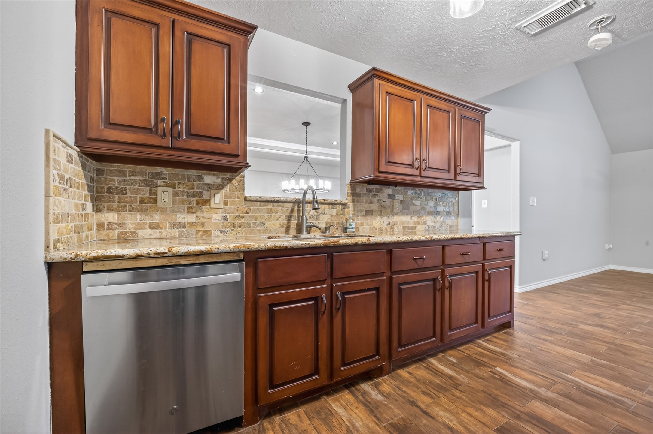 1007 West Cedar River Road Conroe, TX 77316 - Photo 16 of 48 a kitchen with stainless steel appliances granite countertop wooden cabinets a sink and dishwasher with wooden floor