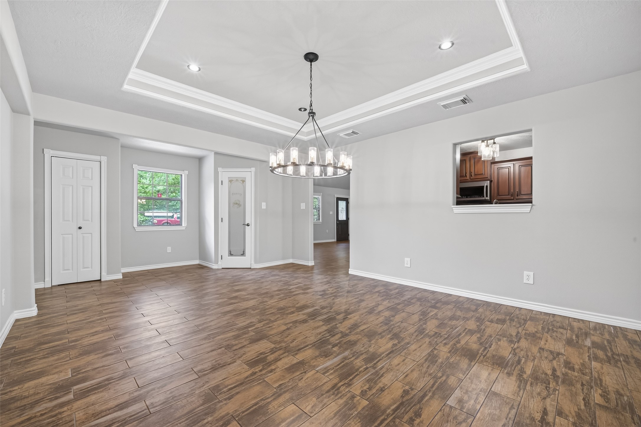 1007 West Cedar River Road Conroe, TX 77316 - Photo 20 of 48 a view of an empty room with window and wooden floor