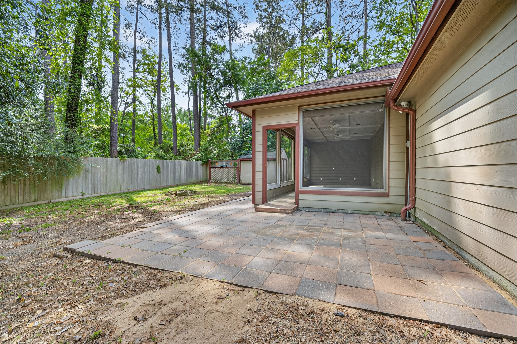 1007 West Cedar River Road Conroe, TX 77316 - Photo 38 of 48 a view of a small house with floor to ceiling window and tree in front of it