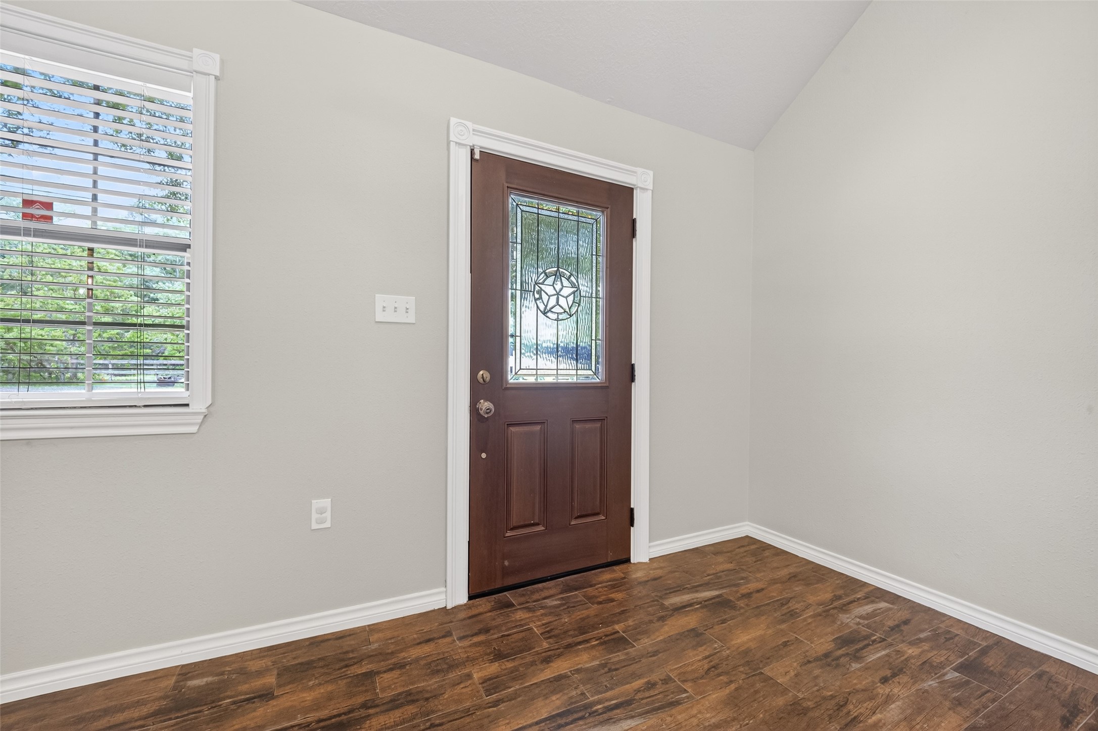 1007 West Cedar River Road Conroe, TX 77316 - Photo 4 of 48 a view of an empty room with wooden floor and a window